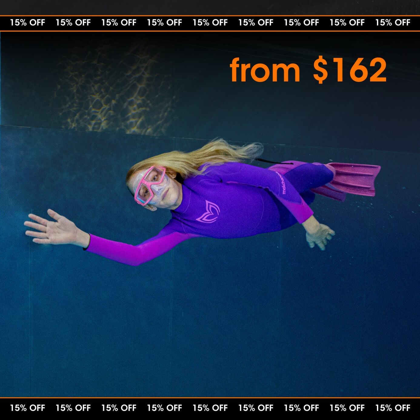 A child swimming with dolphins and wearing a kids wetsuit