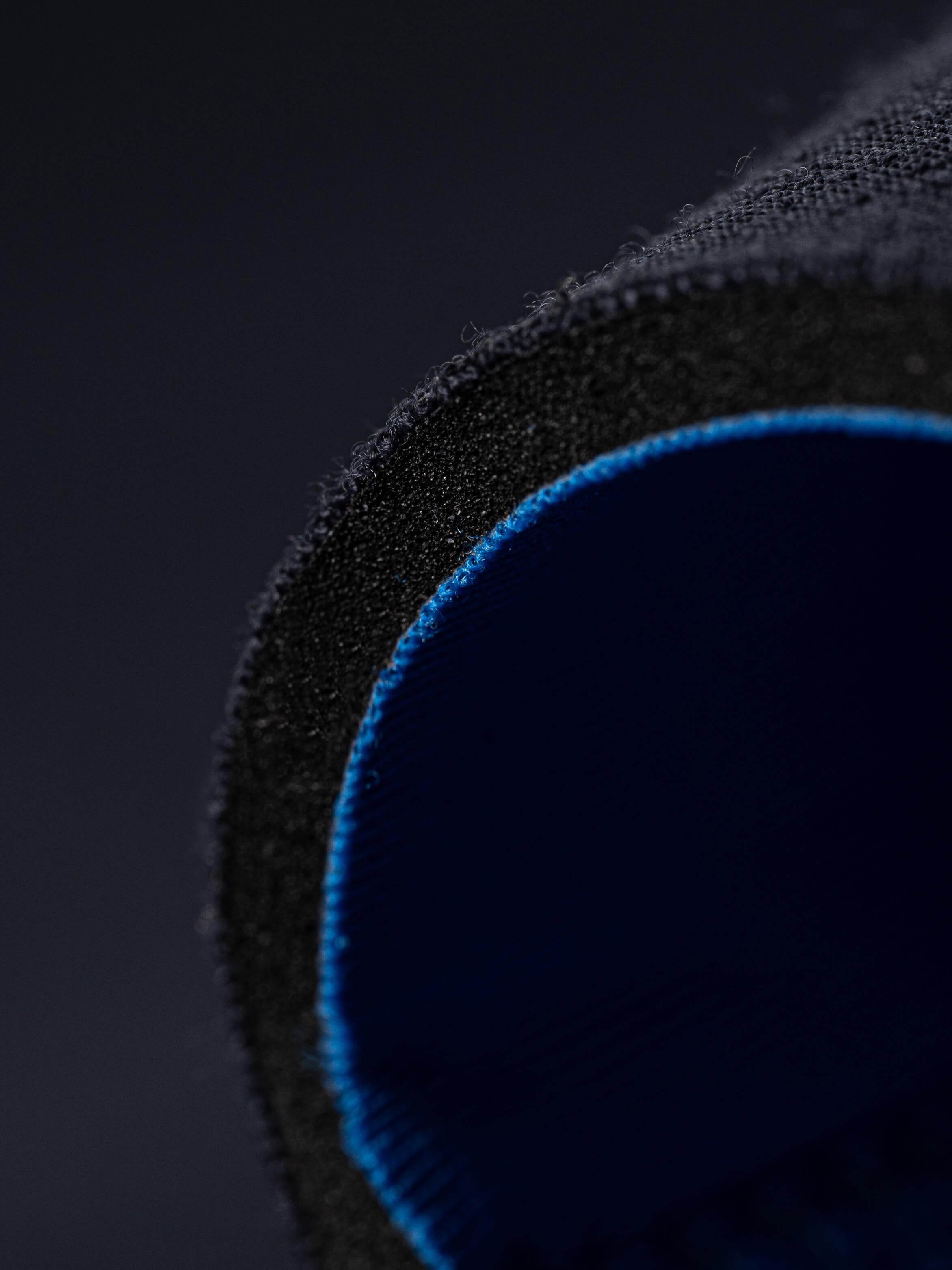 Close up of the thickness of the 5mm mens wetsuit by looking at the wrist seal cut. 