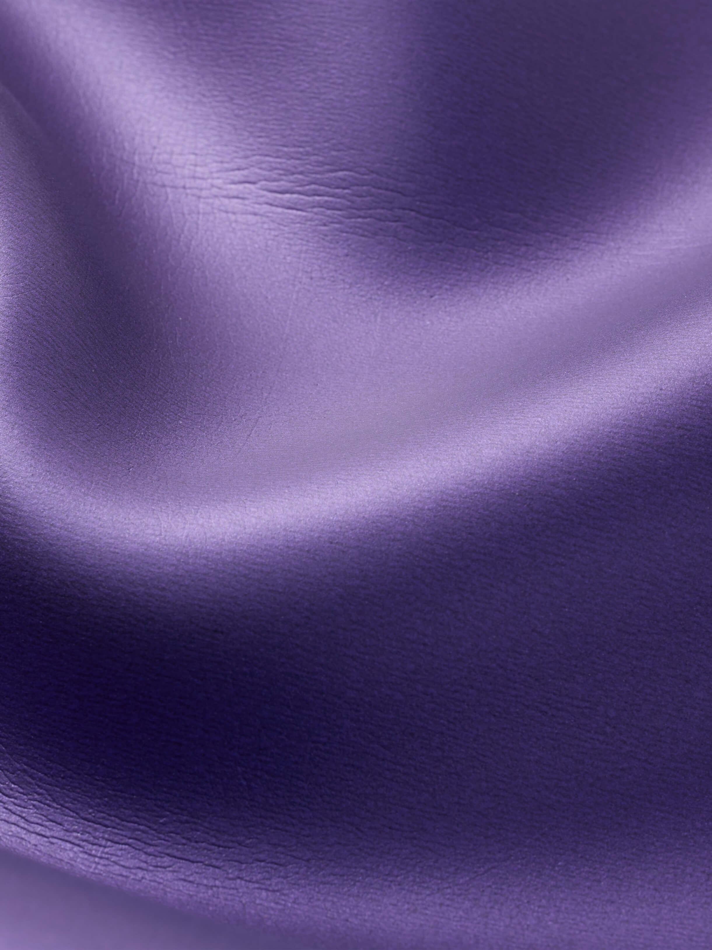 Closeup shot showing the colour of the purple super smooth glide skin coating on the womens competitive two piece freediving wetsuits