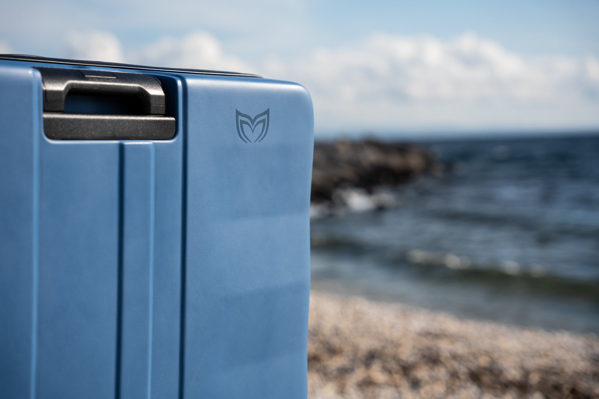 Close up to Molchanovs logo on blue hard case and beach background